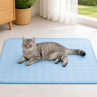 Gray cat lying on a light blue washable pet cooling mat